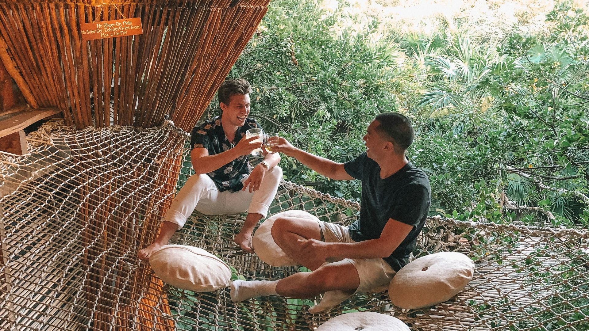 man in black crew neck t-shirt sitting on brown wicker chair