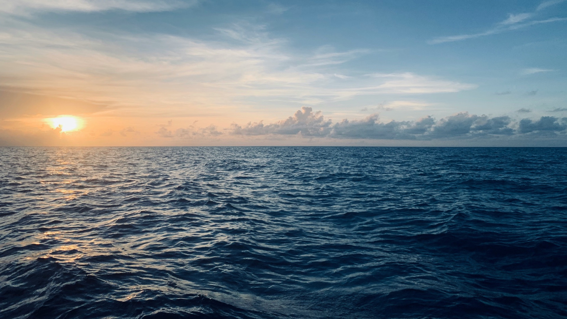 body of water under blue sky during sunset