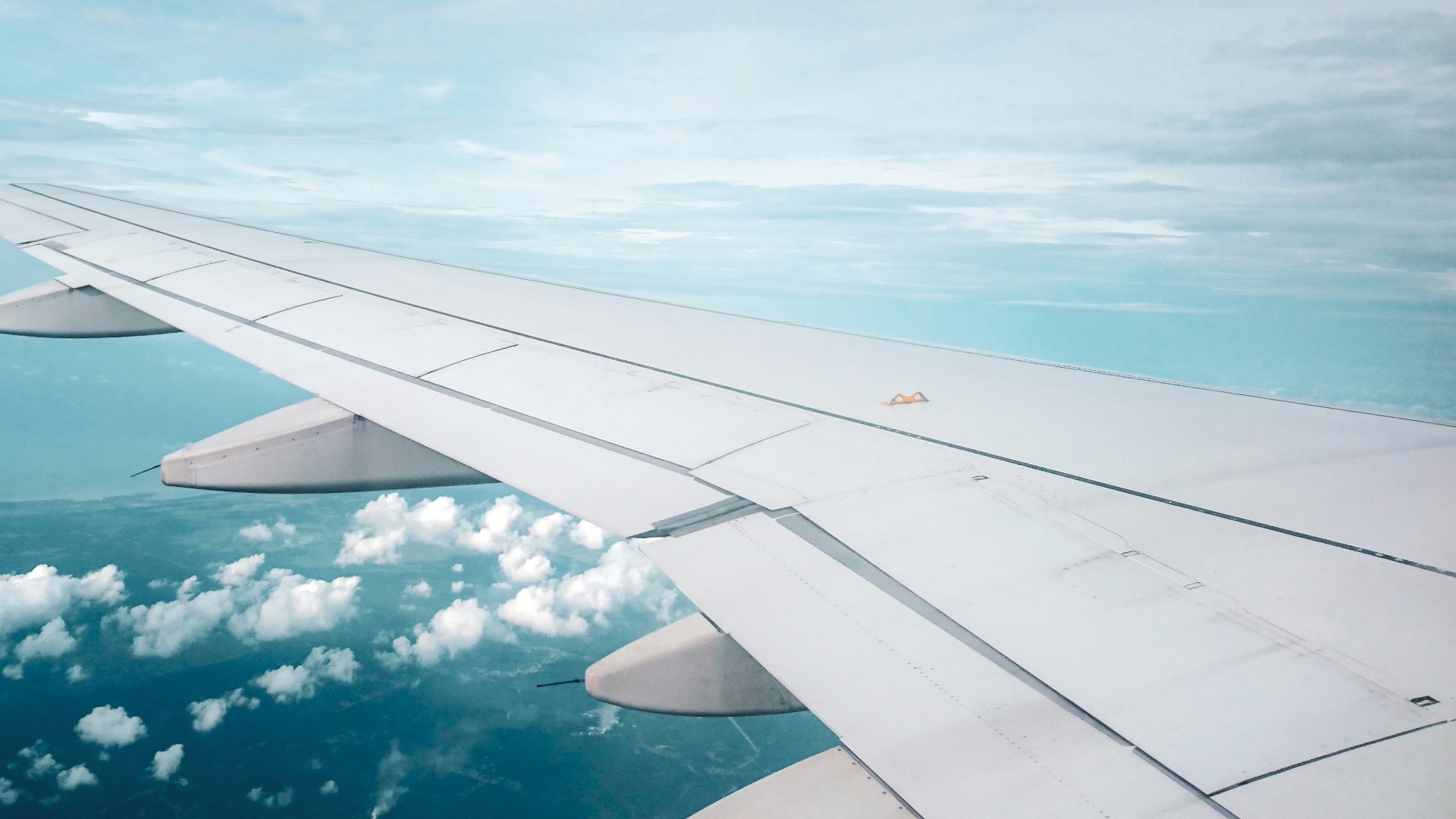 plane flying over white clouds formation