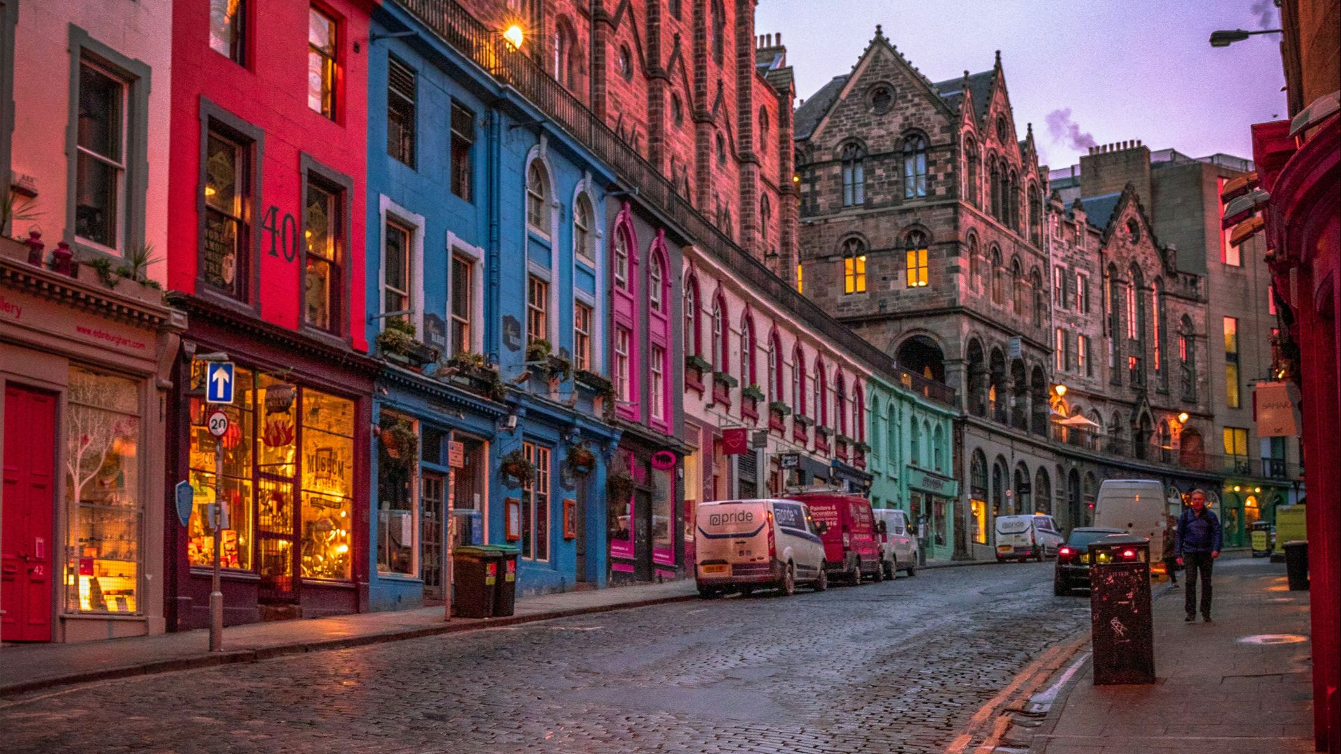 people walking on sidewalk near red concrete building during daytime