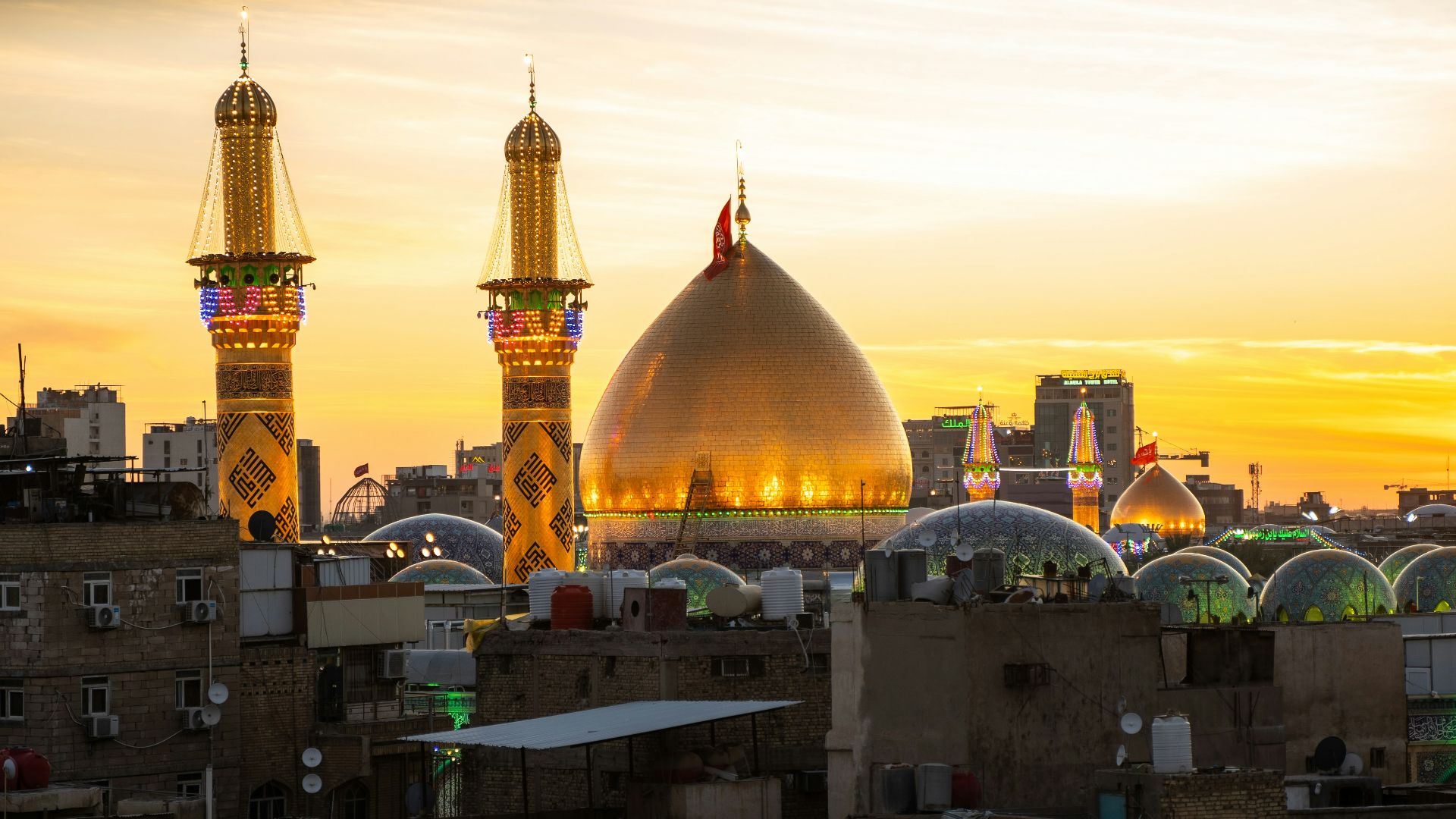 A sunset view of a city with tall buildings