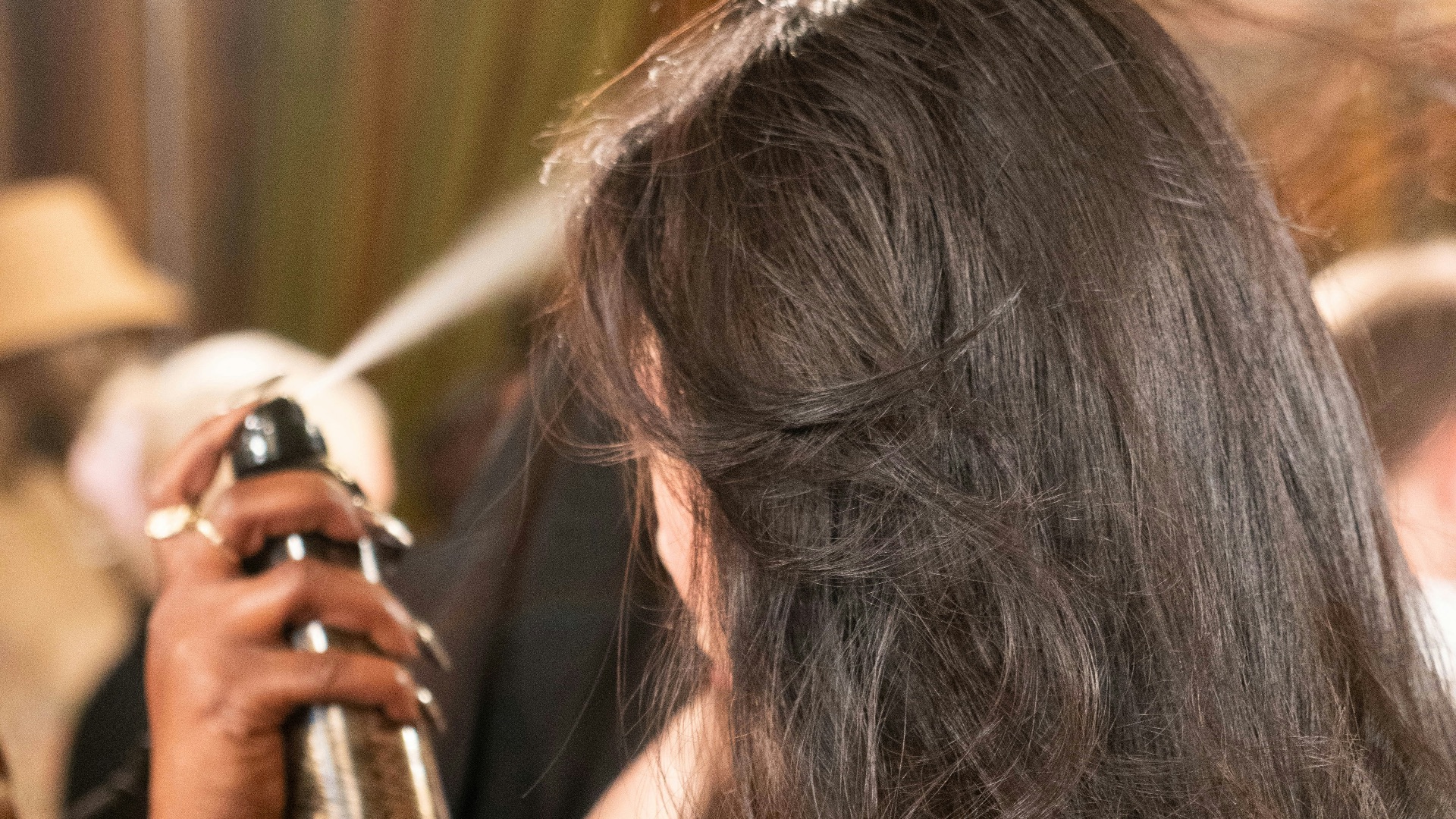 a woman is blow drying her long hair