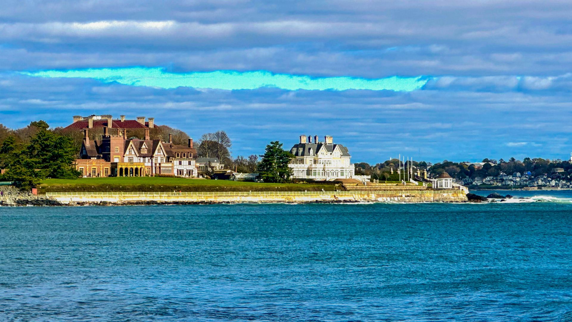 a large body of water with houses in the background