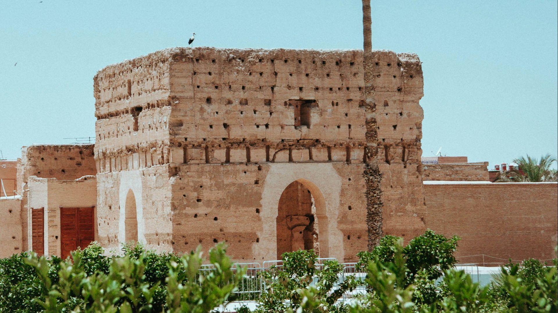 brown concrete building near green trees during daytime