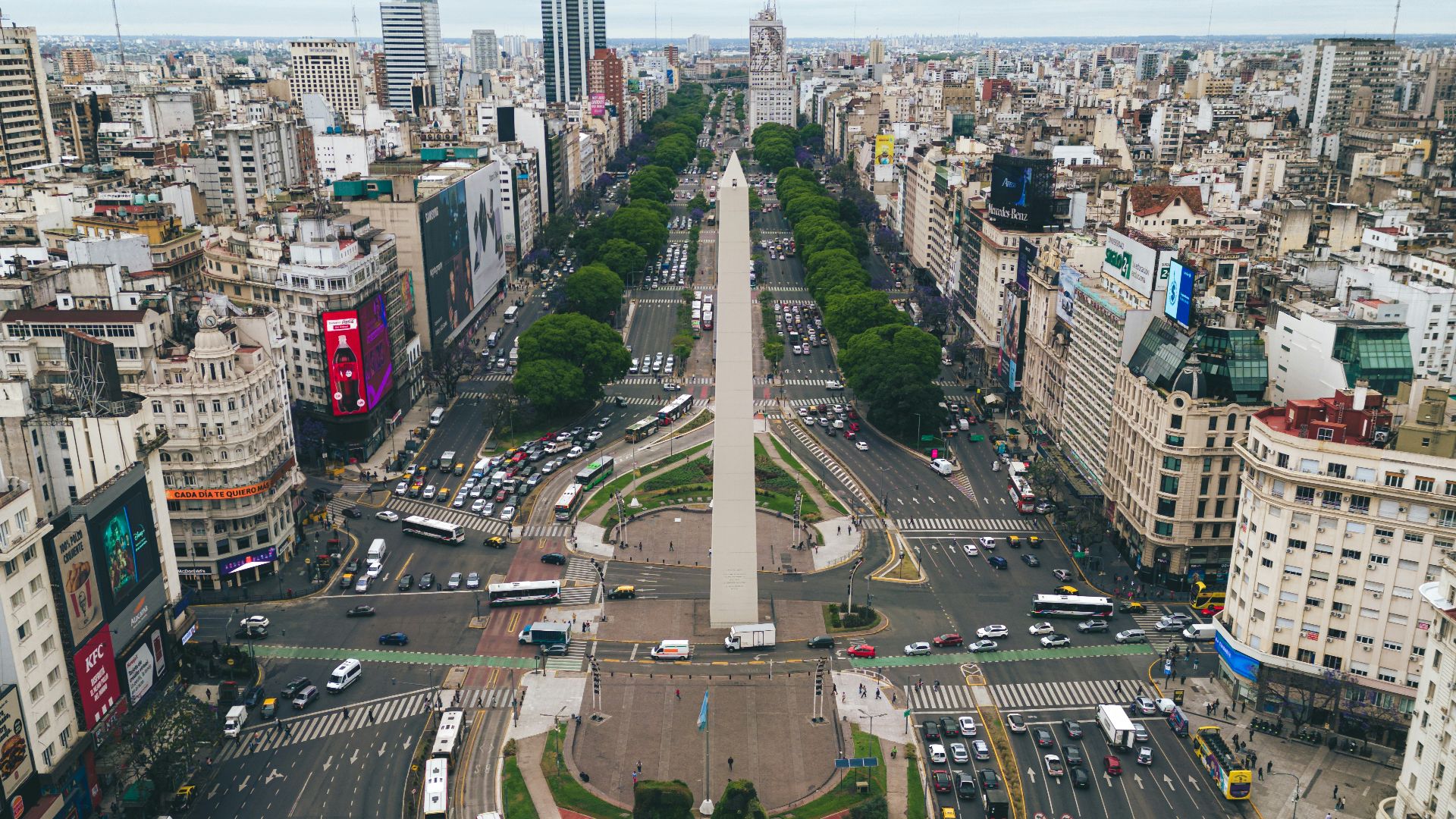 an aerial view of a city with a monument in the middle