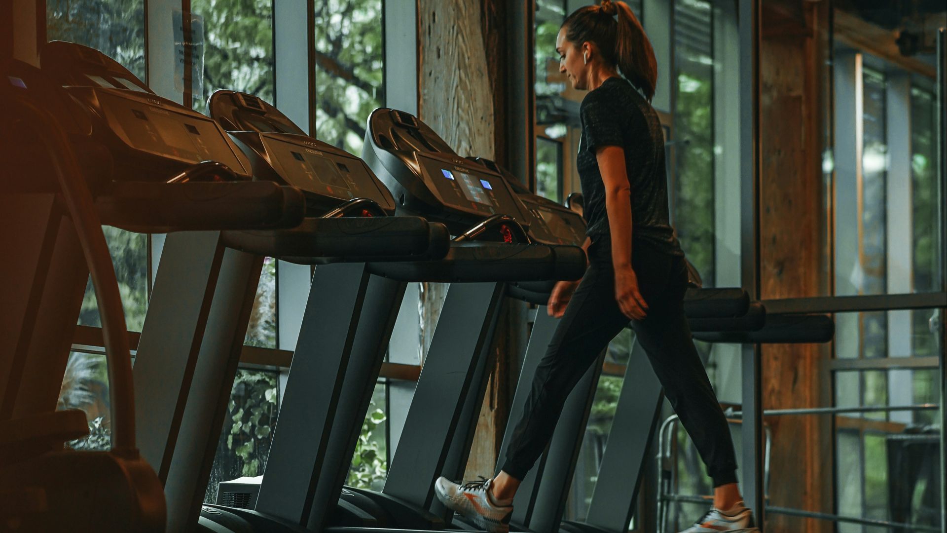 a woman running on a treadmill in a gym