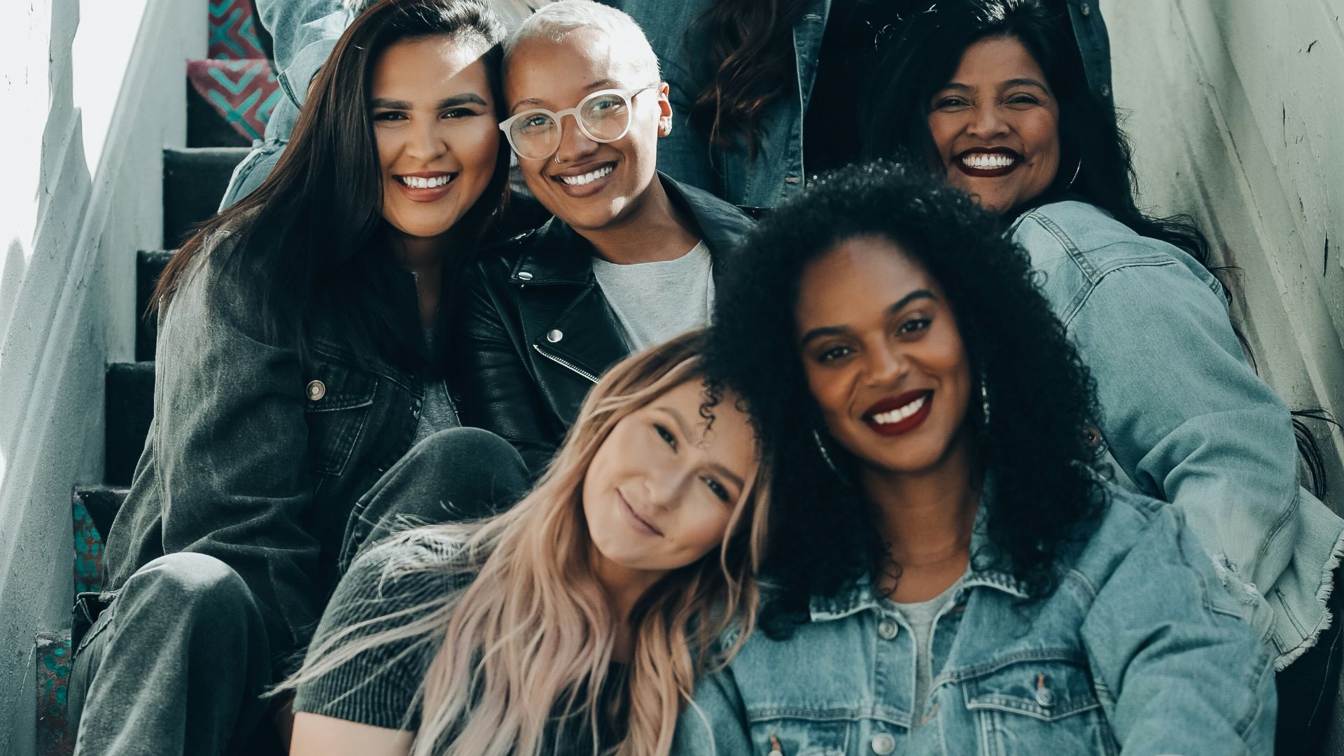 2 women sitting on black chair