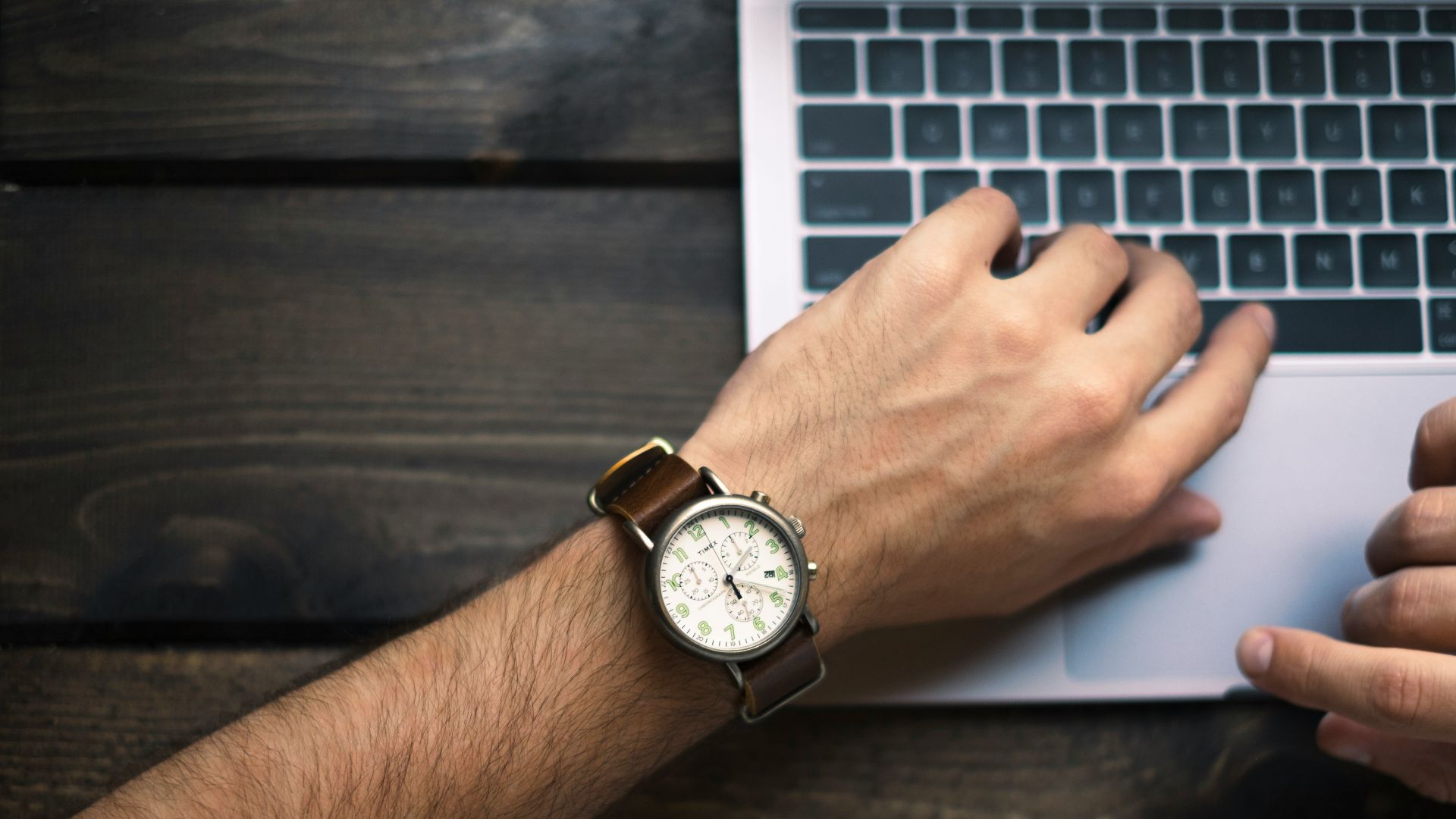 person wearing brown and white watch