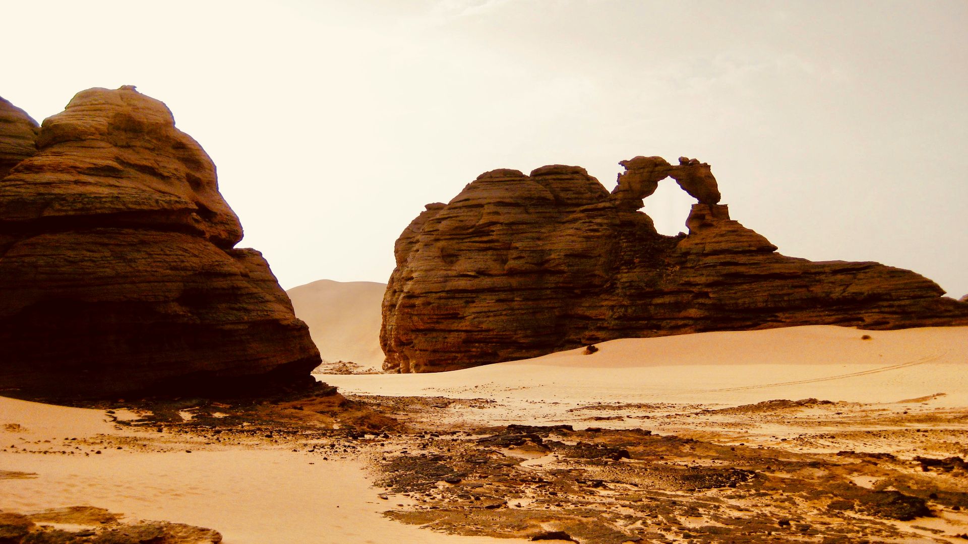 a desert scene with rocks and sand in the foreground