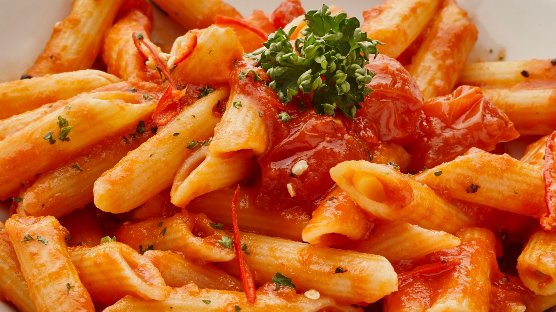 a white plate topped with pasta covered in sauce