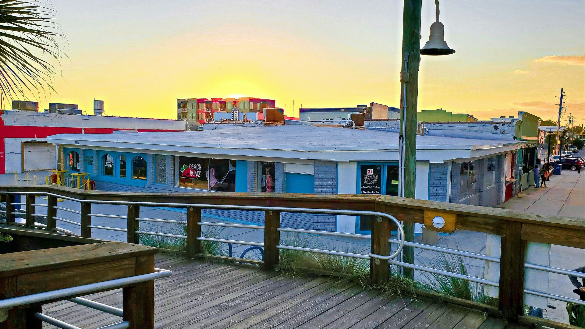 a view of a boardwalk with buildings in the background