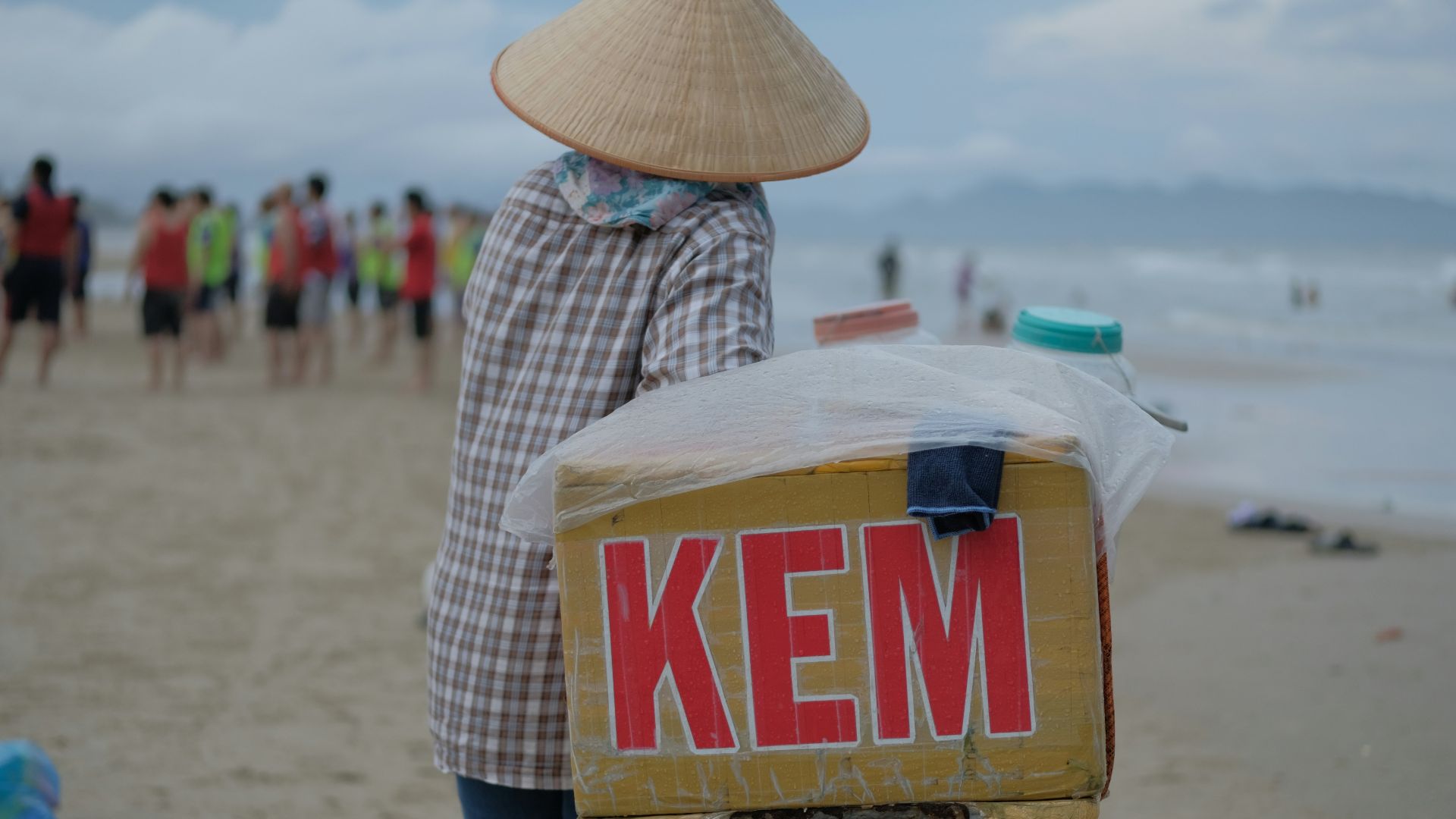 a person pushing a cart with a sign on it