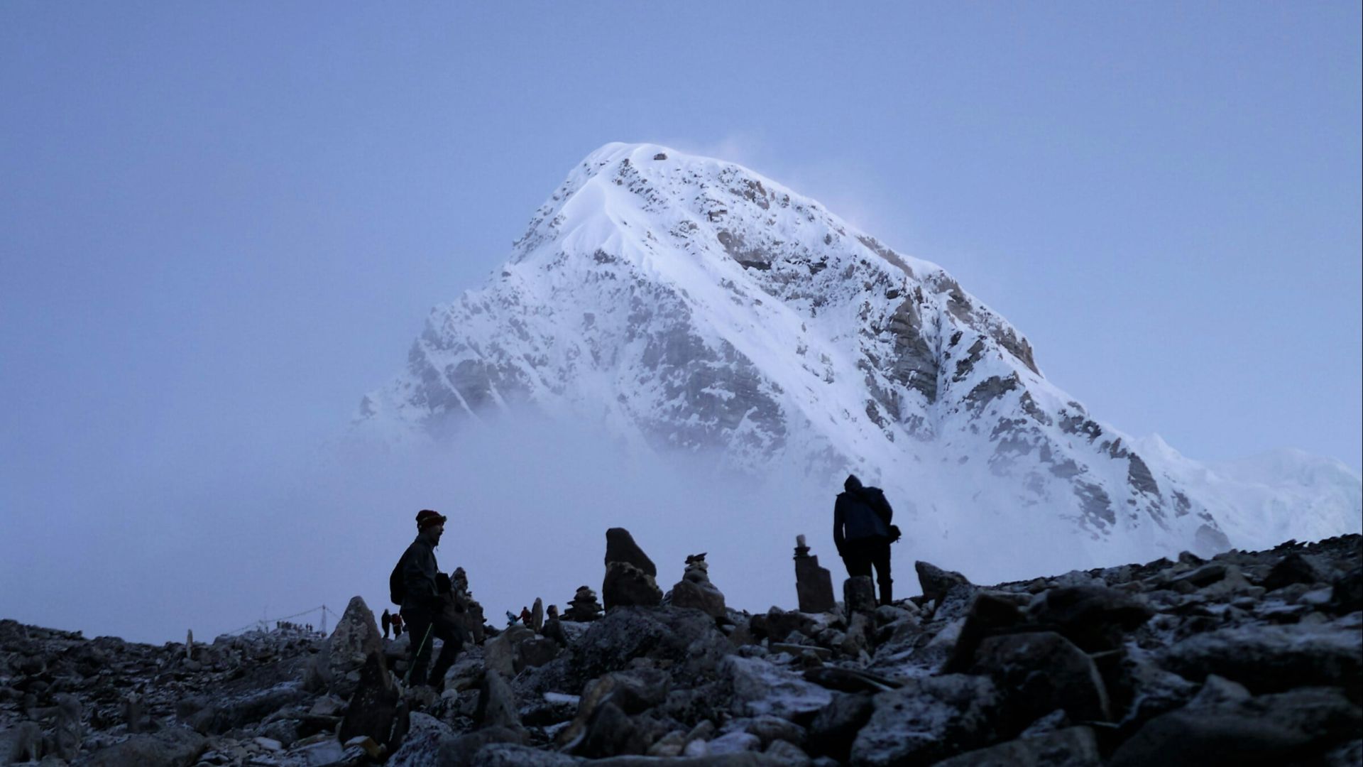 mountaineers near snow-covered mountain