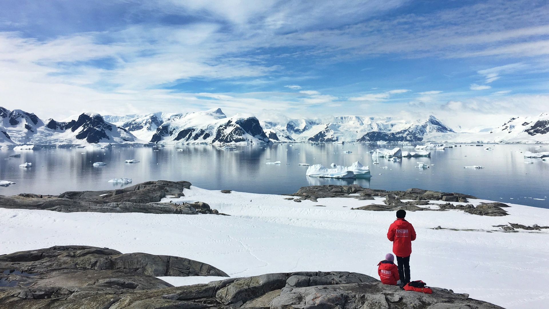 two person standing on snow field