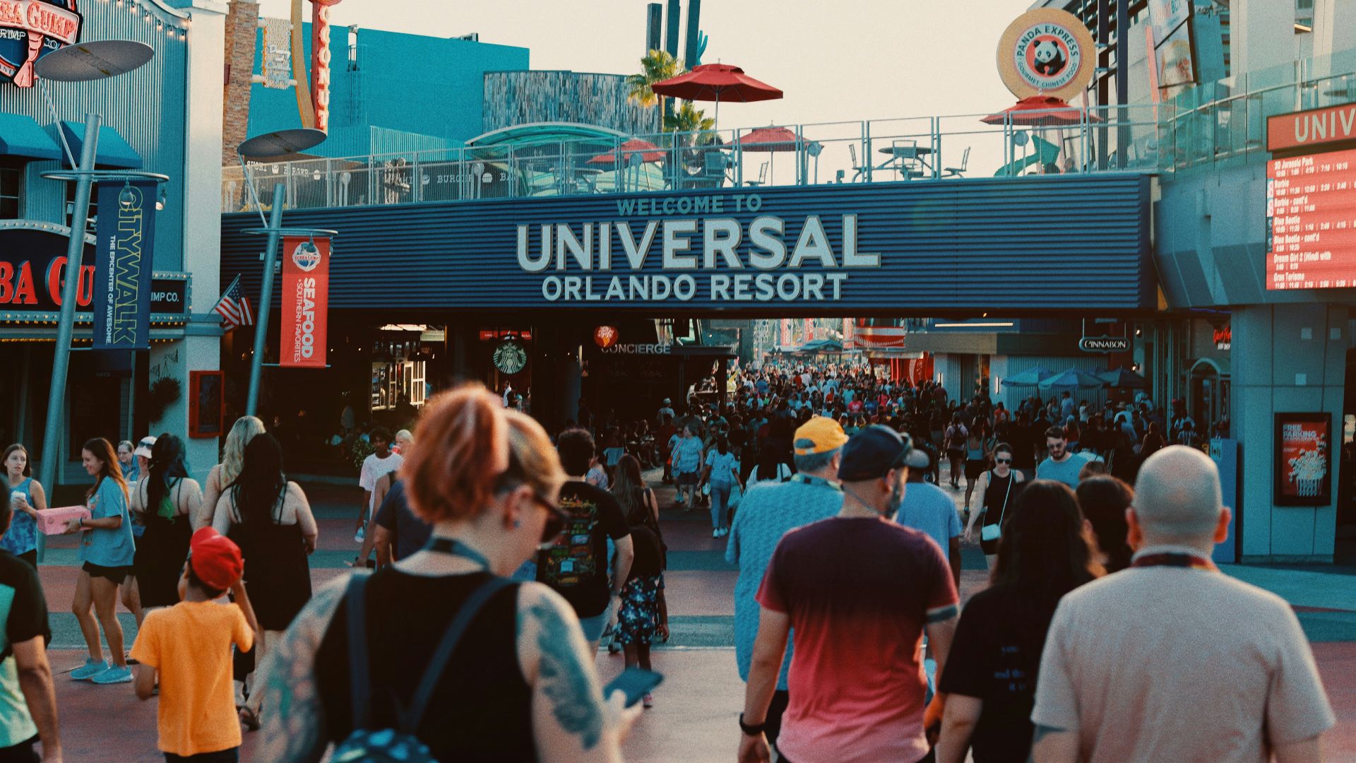 a crowd of people walking down a street next to a building