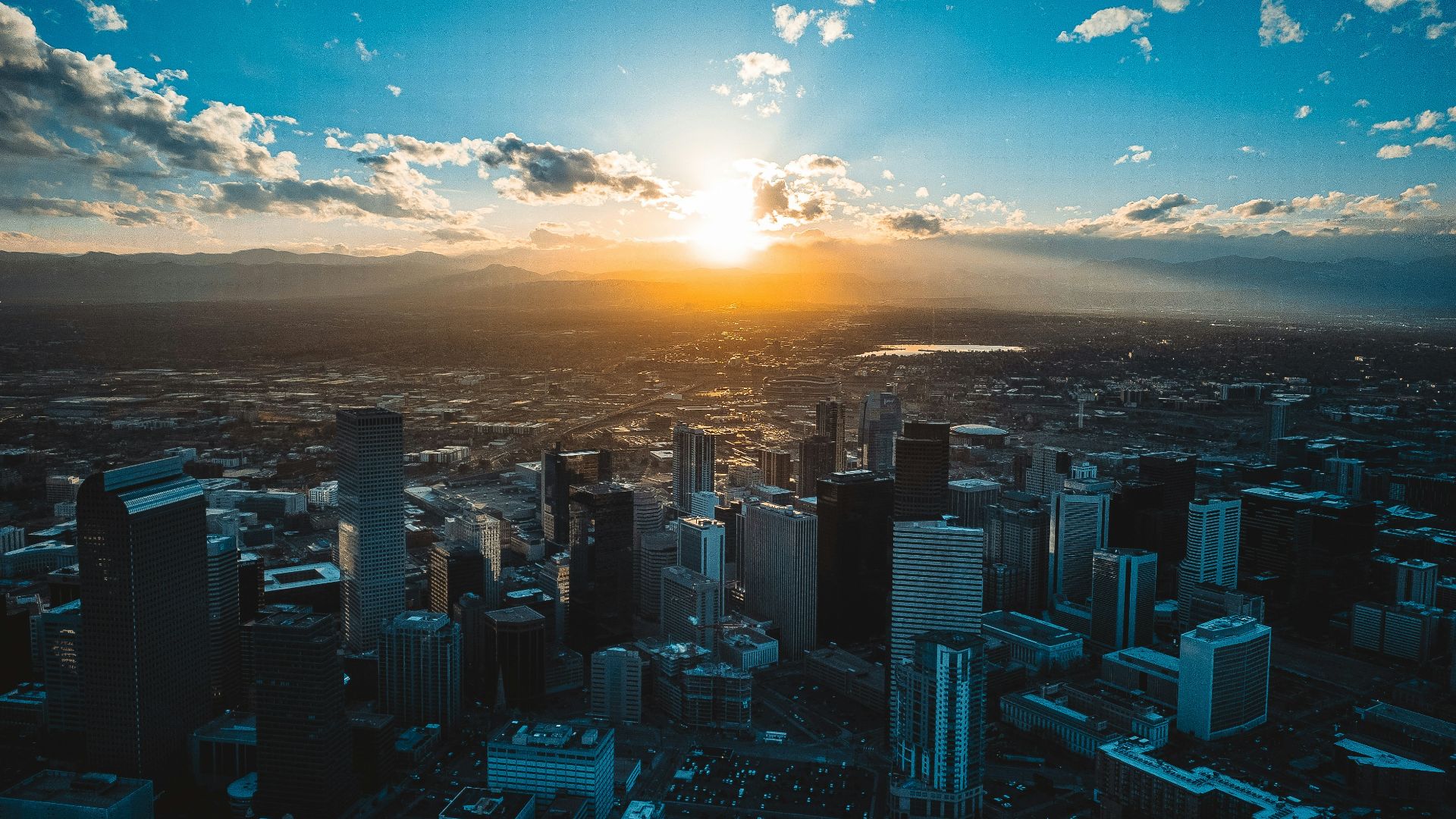 the sun is setting over a large city
