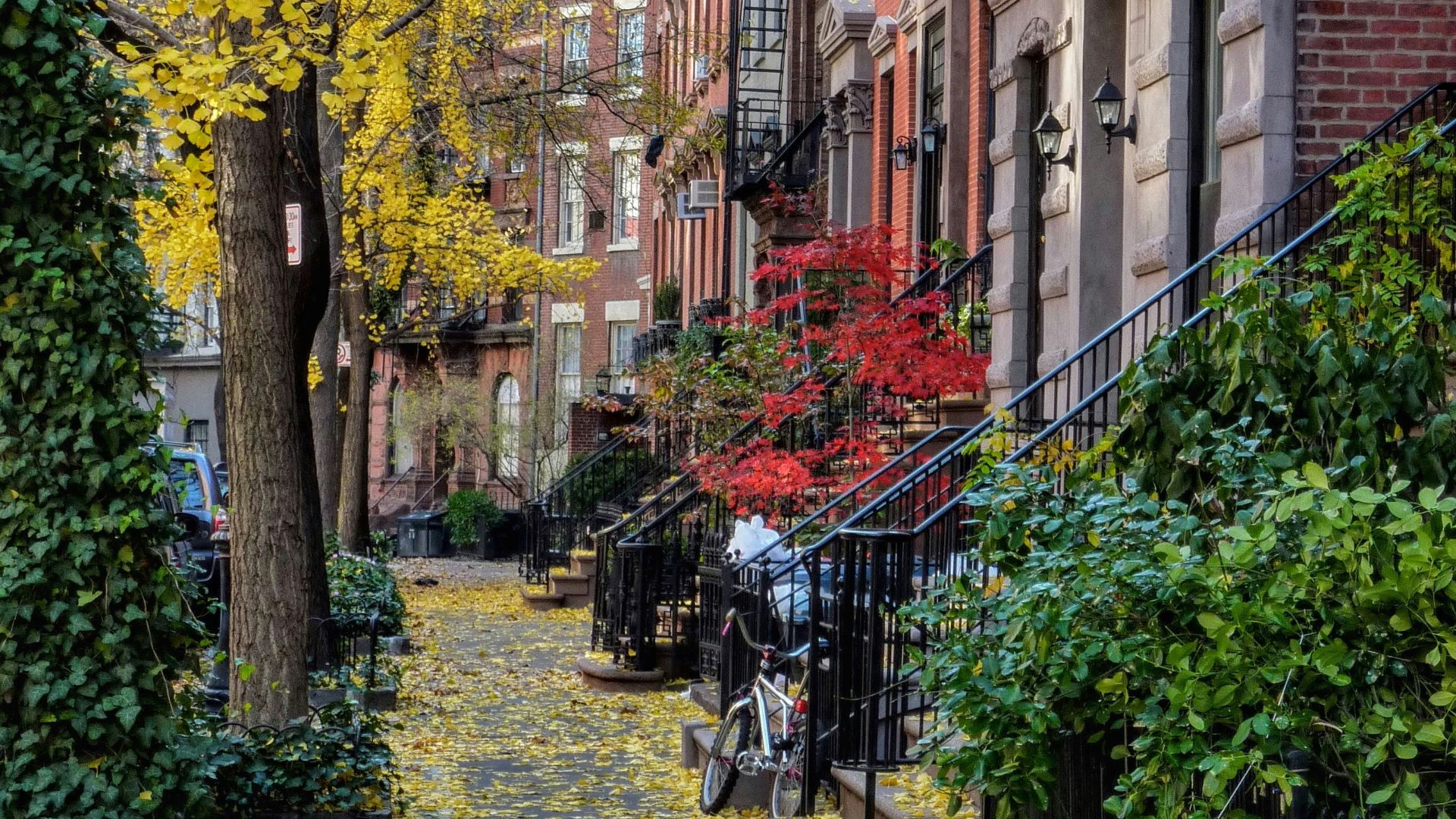 bicycle parked beside brown concrete building during daytime