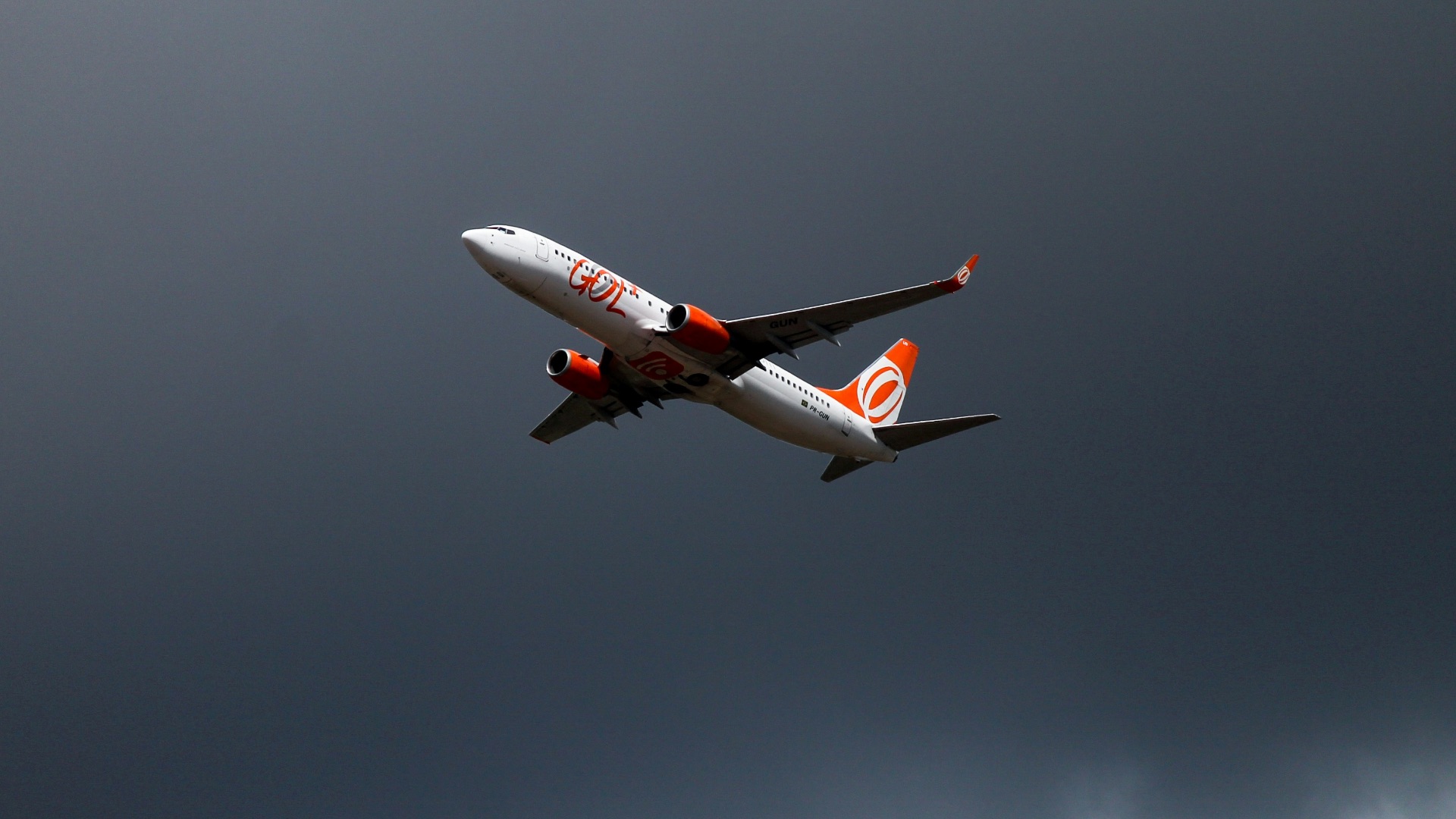 orange and white airliner on flight