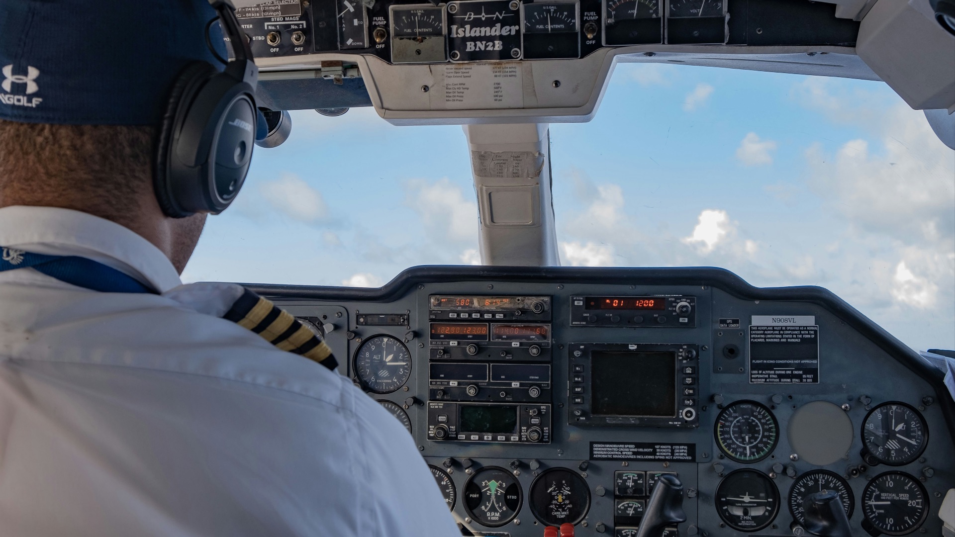 person in white shirt driving car