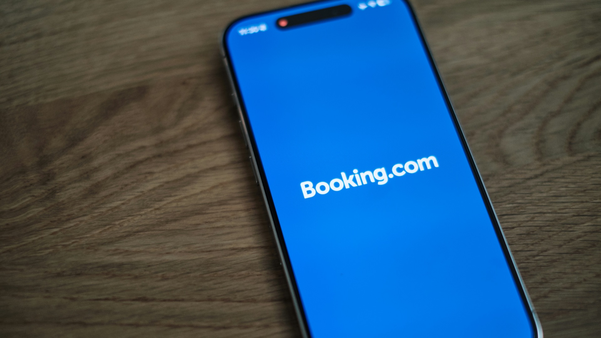 A blue samsung phone with the logo of bookking com on it