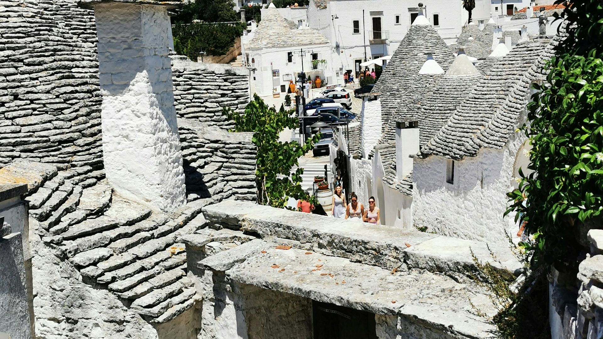 a stone wall with a building in the background