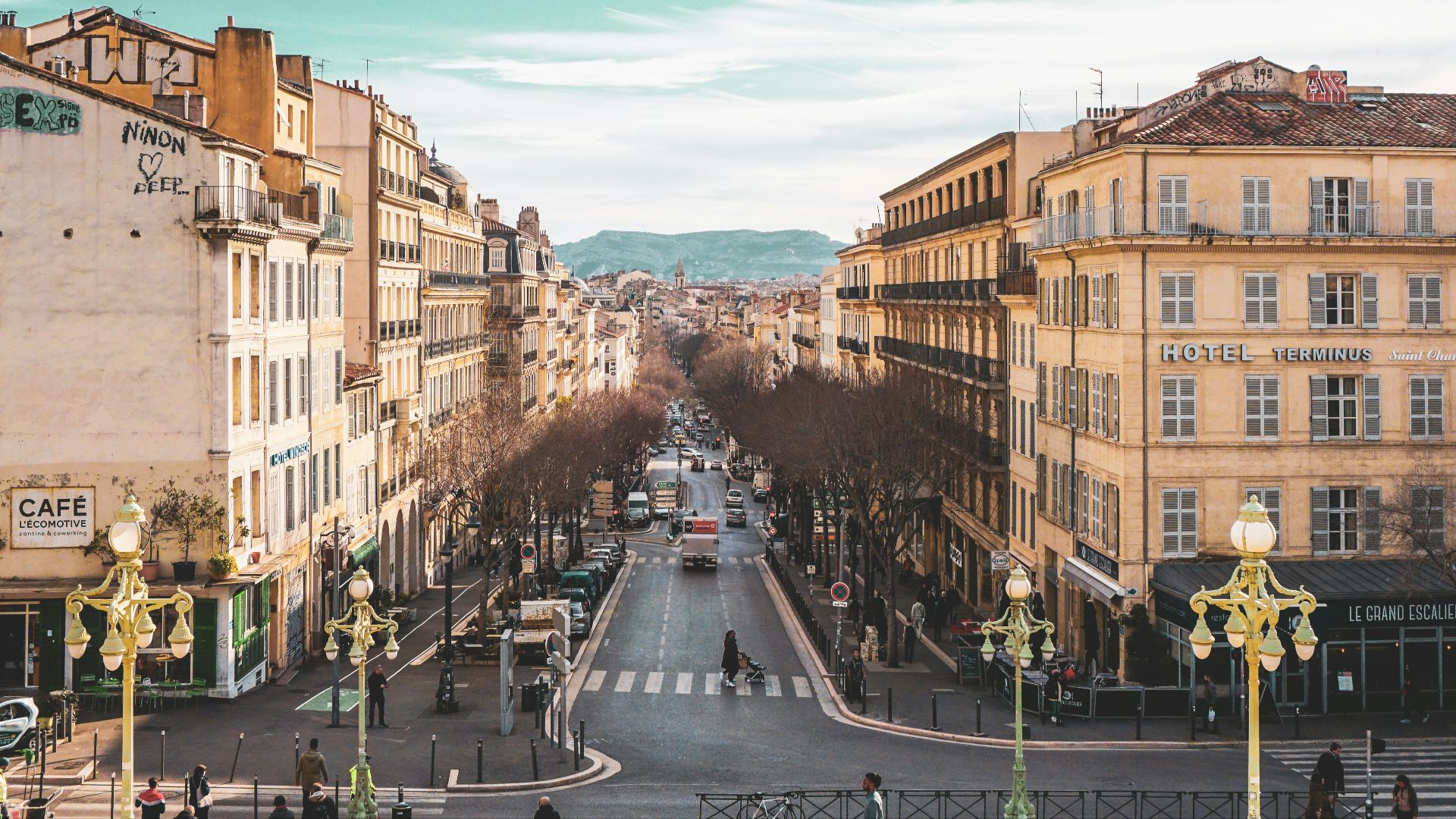 people walking on street between buildings during daytime