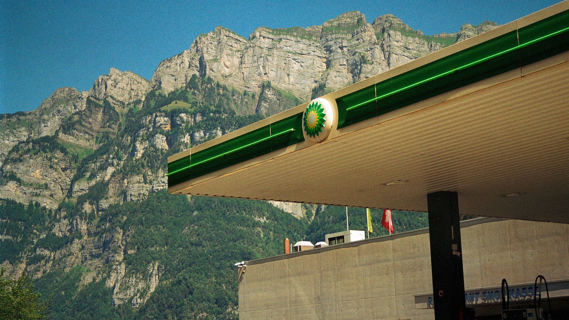 a gas station with mountains in the background