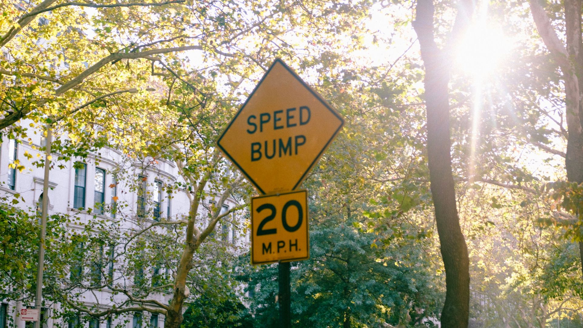 a speed bump sign on a street corner