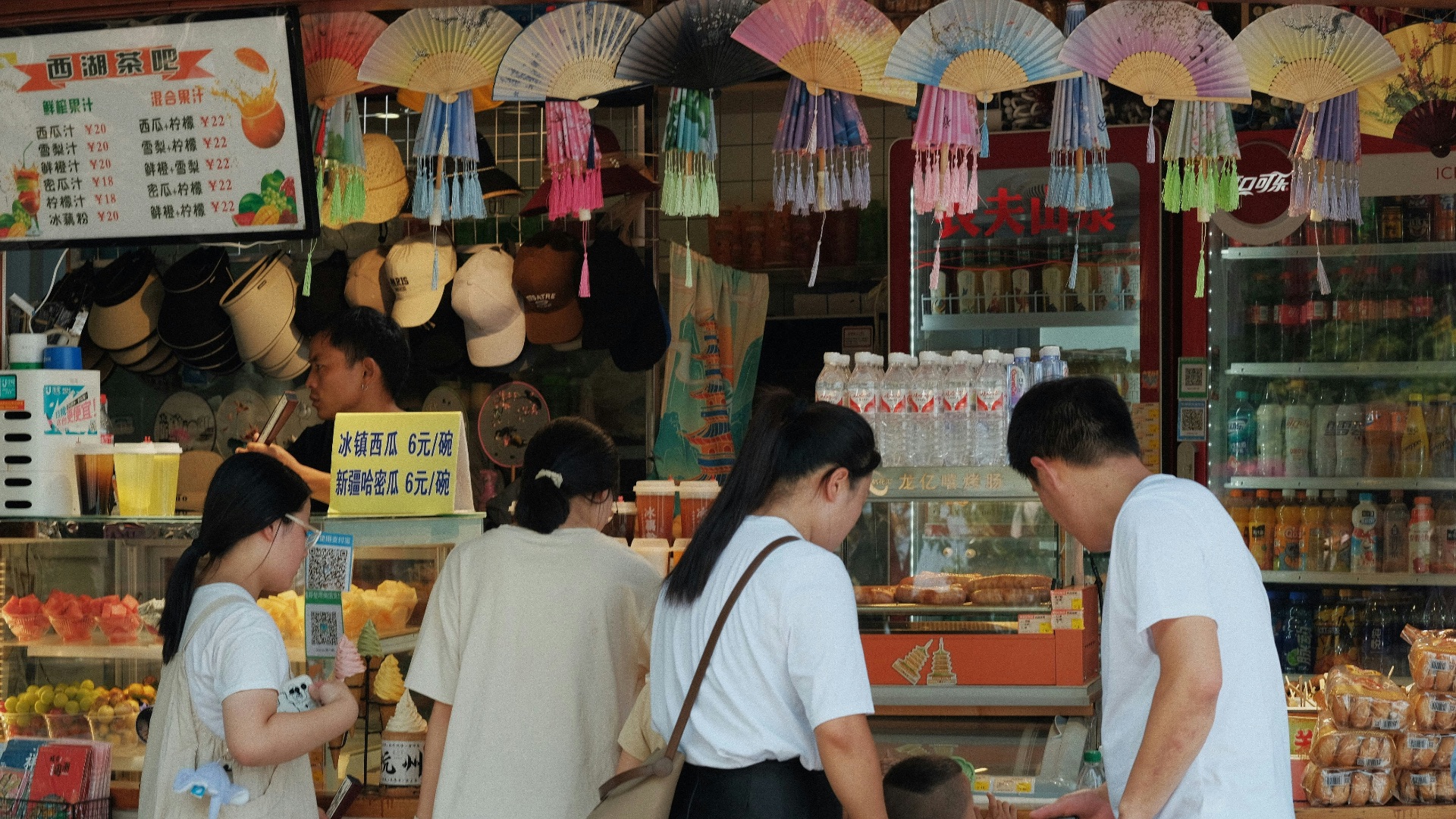 A group of people standing in front of a store