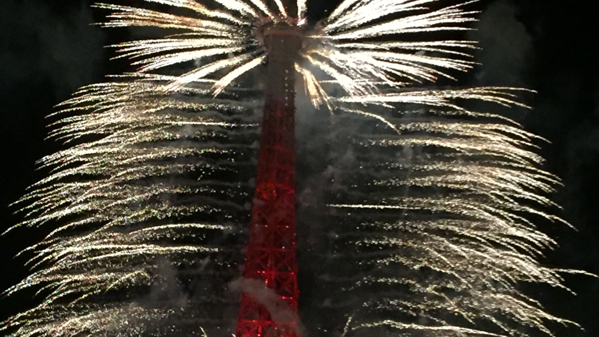 File:Eiffel Tower lit in red with fireworks on Bastille Day.jpg