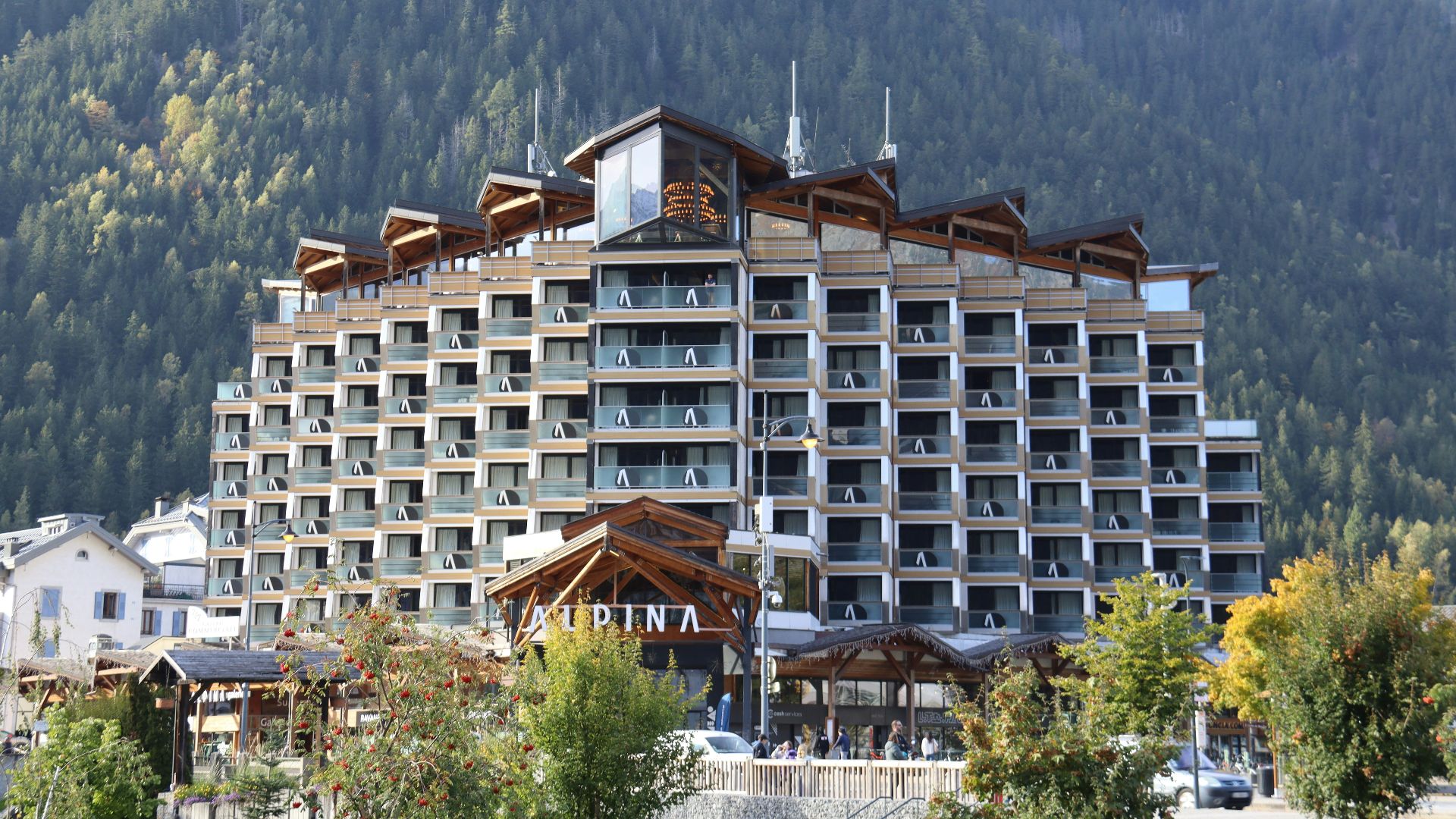 Modern hotel building nestled in a mountain landscape.