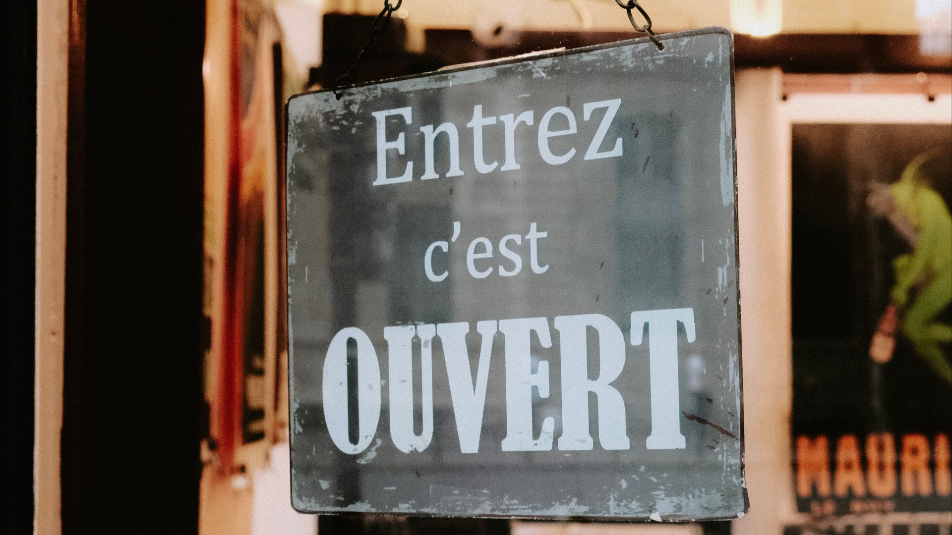 a sign hanging from the side of a building