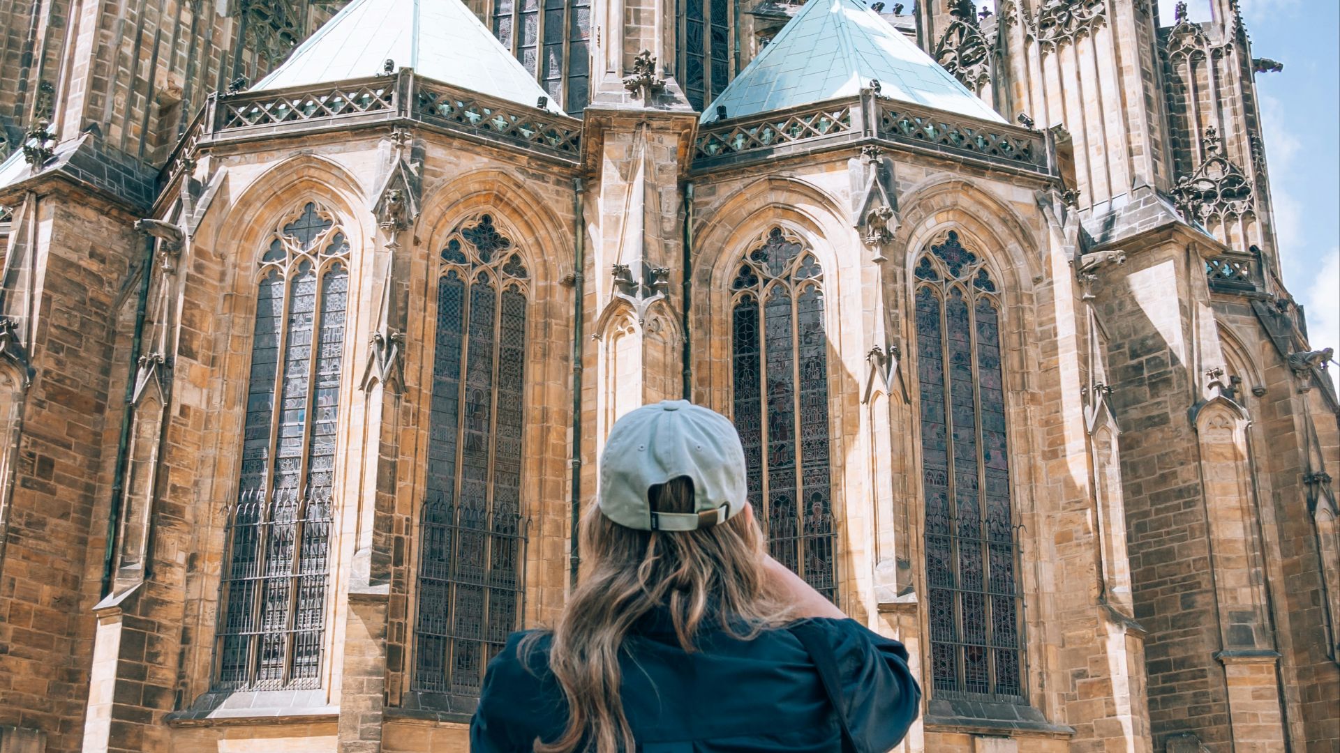 a woman standing in front of a large cathedral