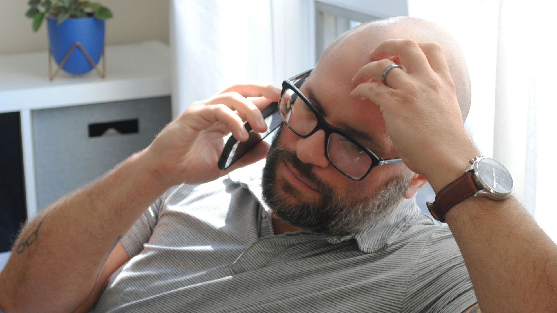 a man with glasses and a watch