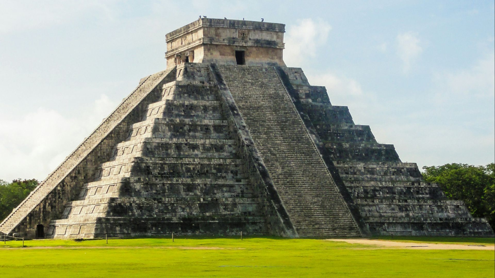 gray concrete building on green grass field during daytime