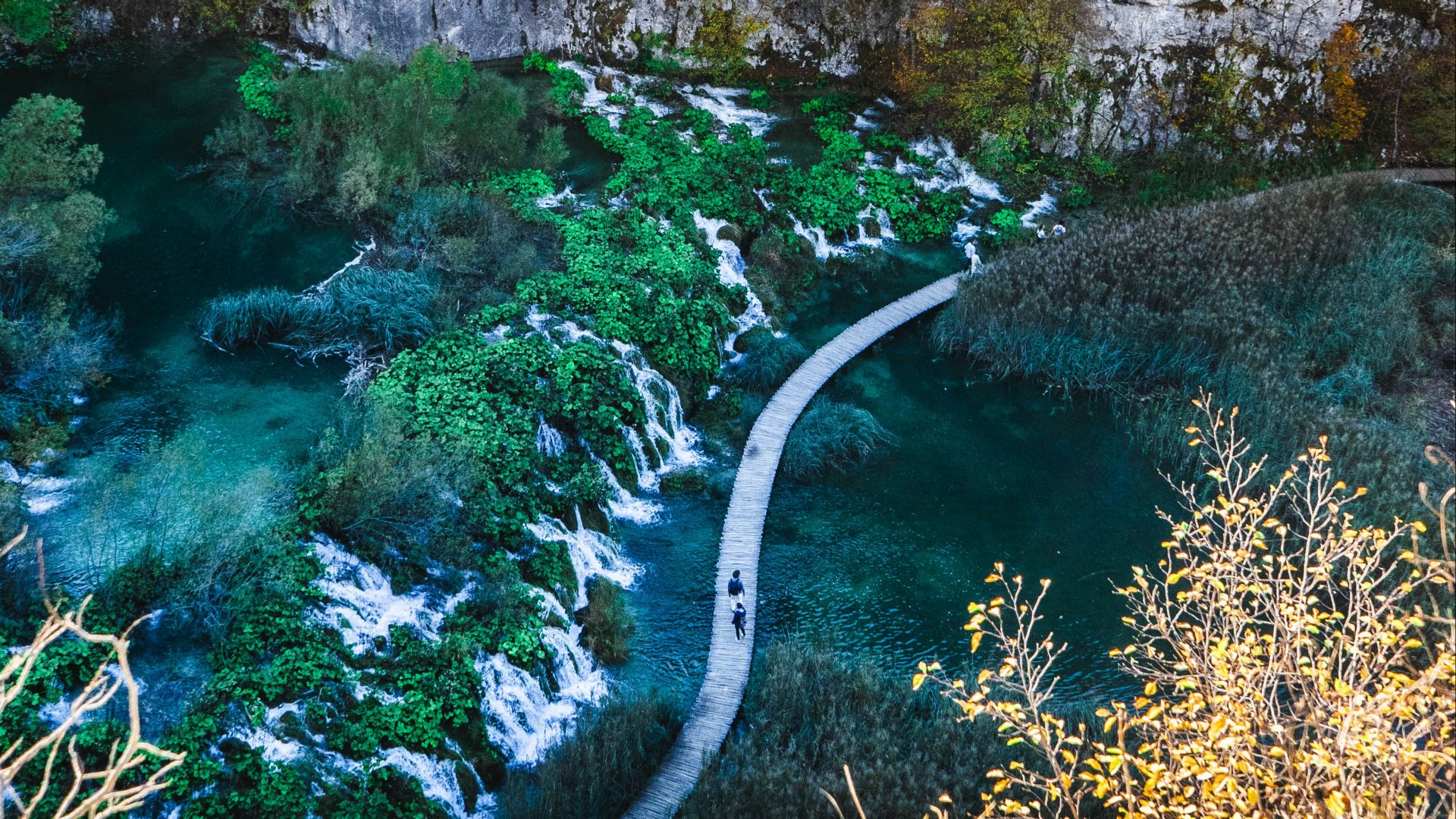 a river flowing through a canyon next to a cliff