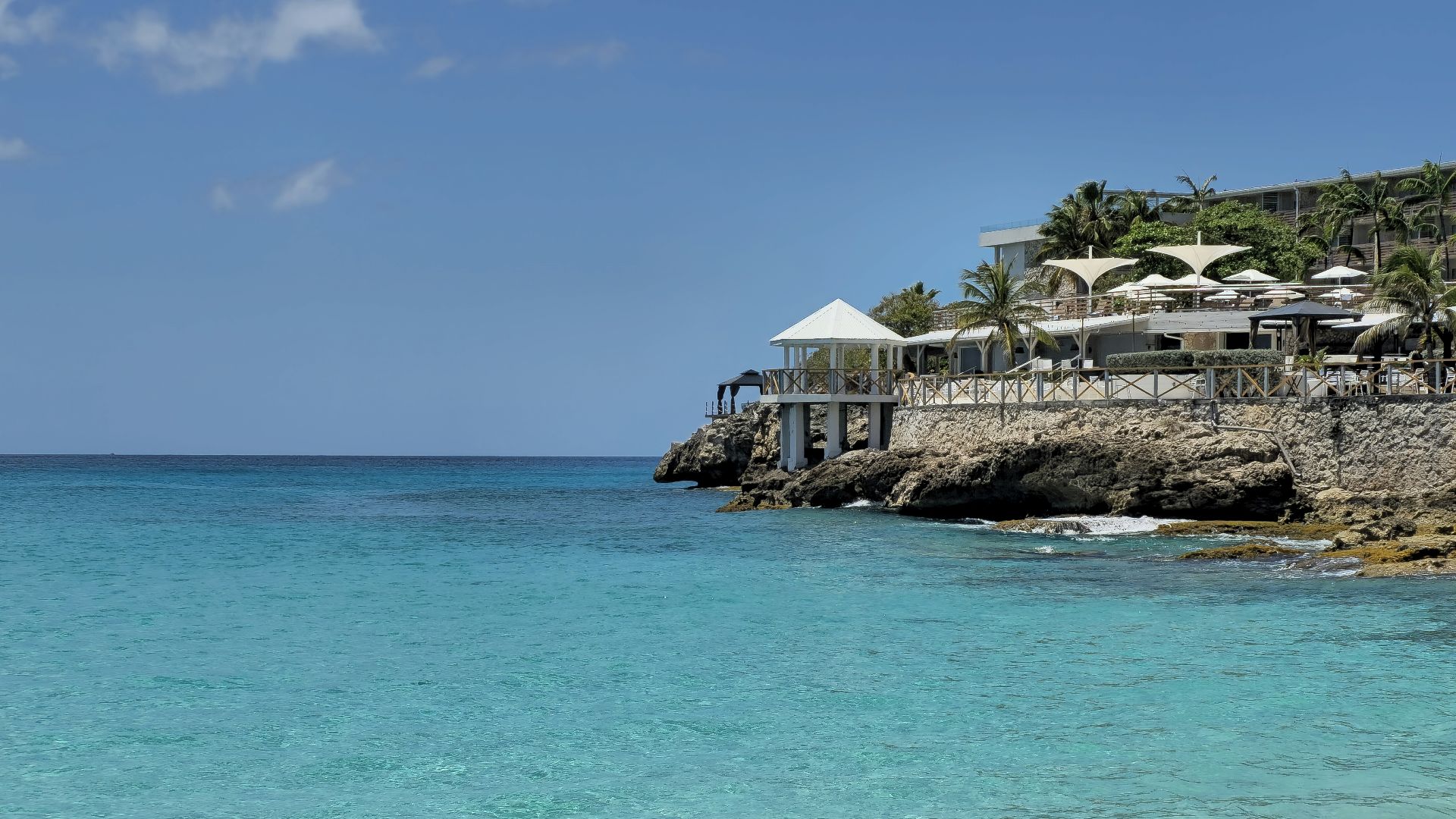 a view of a beach with a restaurant in the background