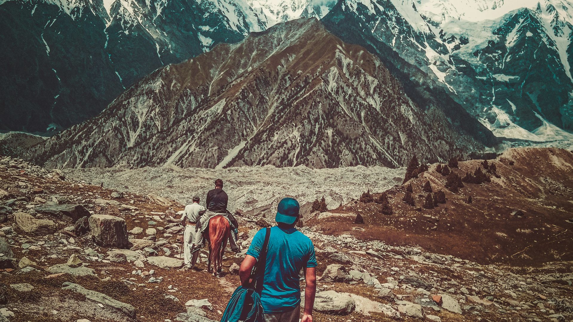 a couple of people that are walking in the dirt