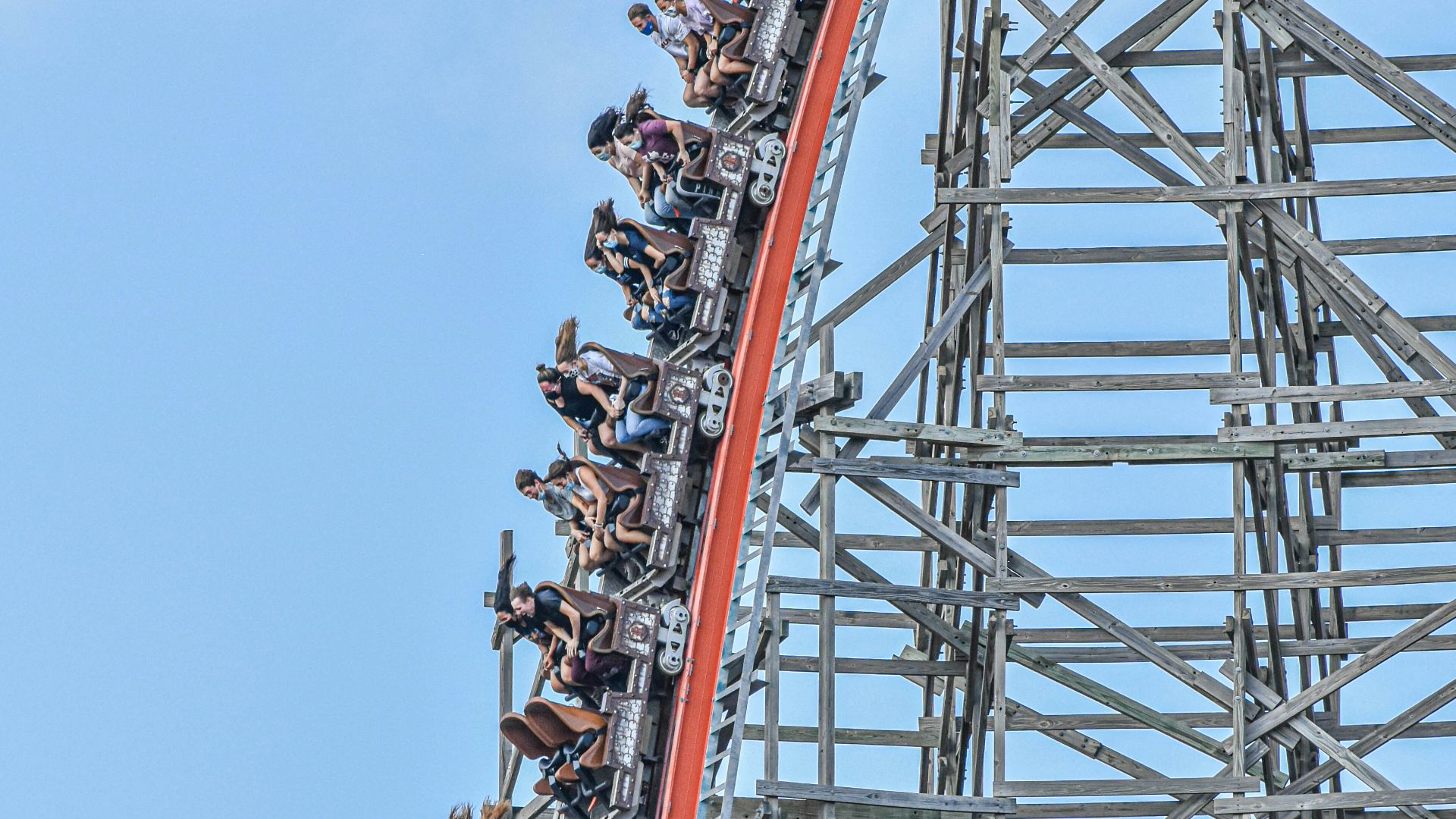 people riding roller coaster during daytime