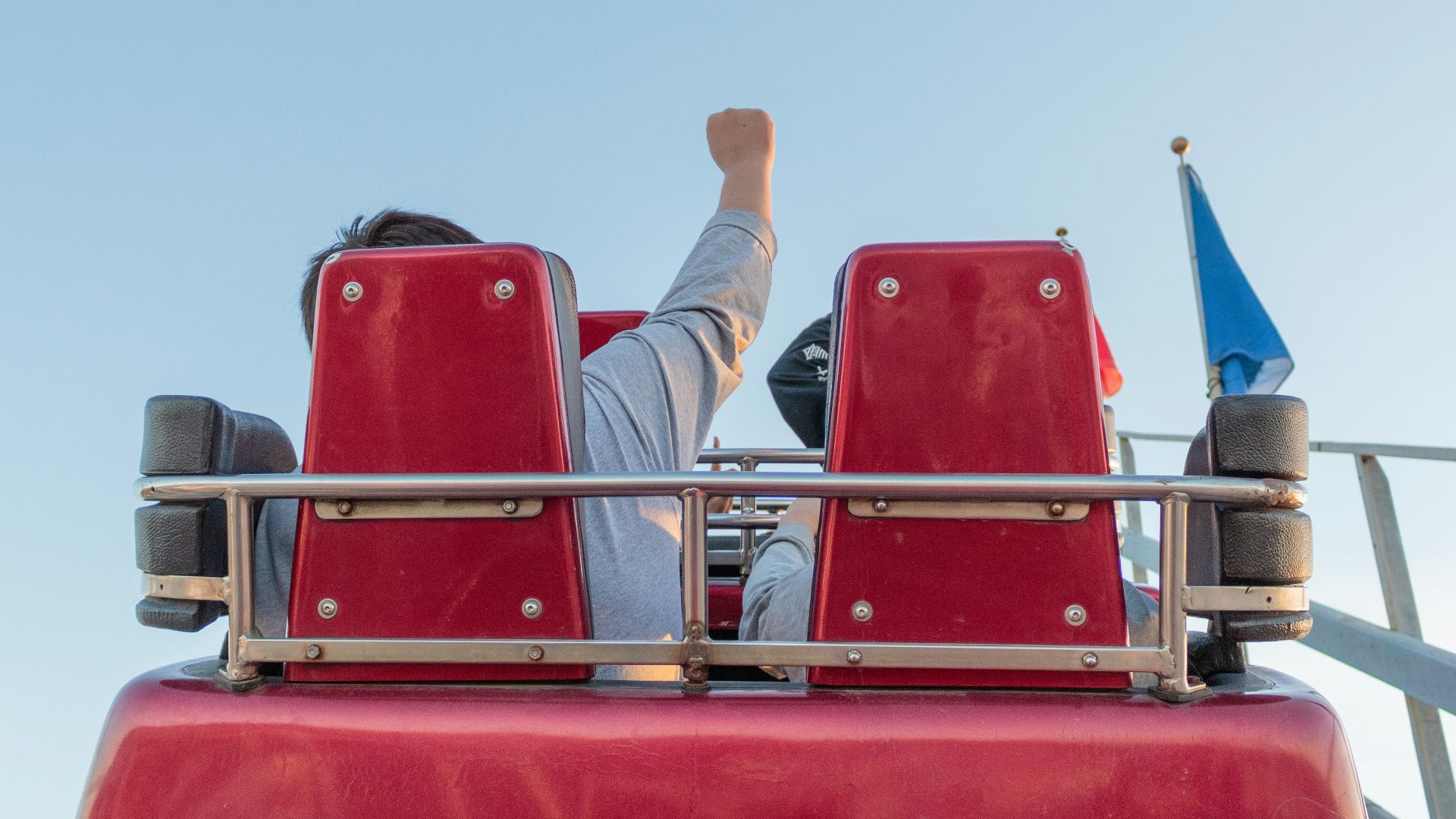 2 men sitting on red chair