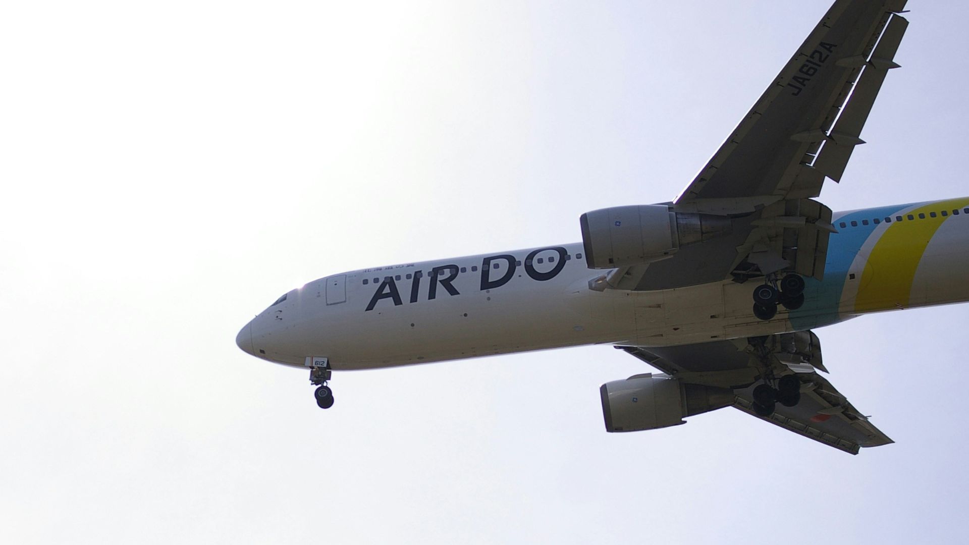 a large jetliner flying through a cloudy sky