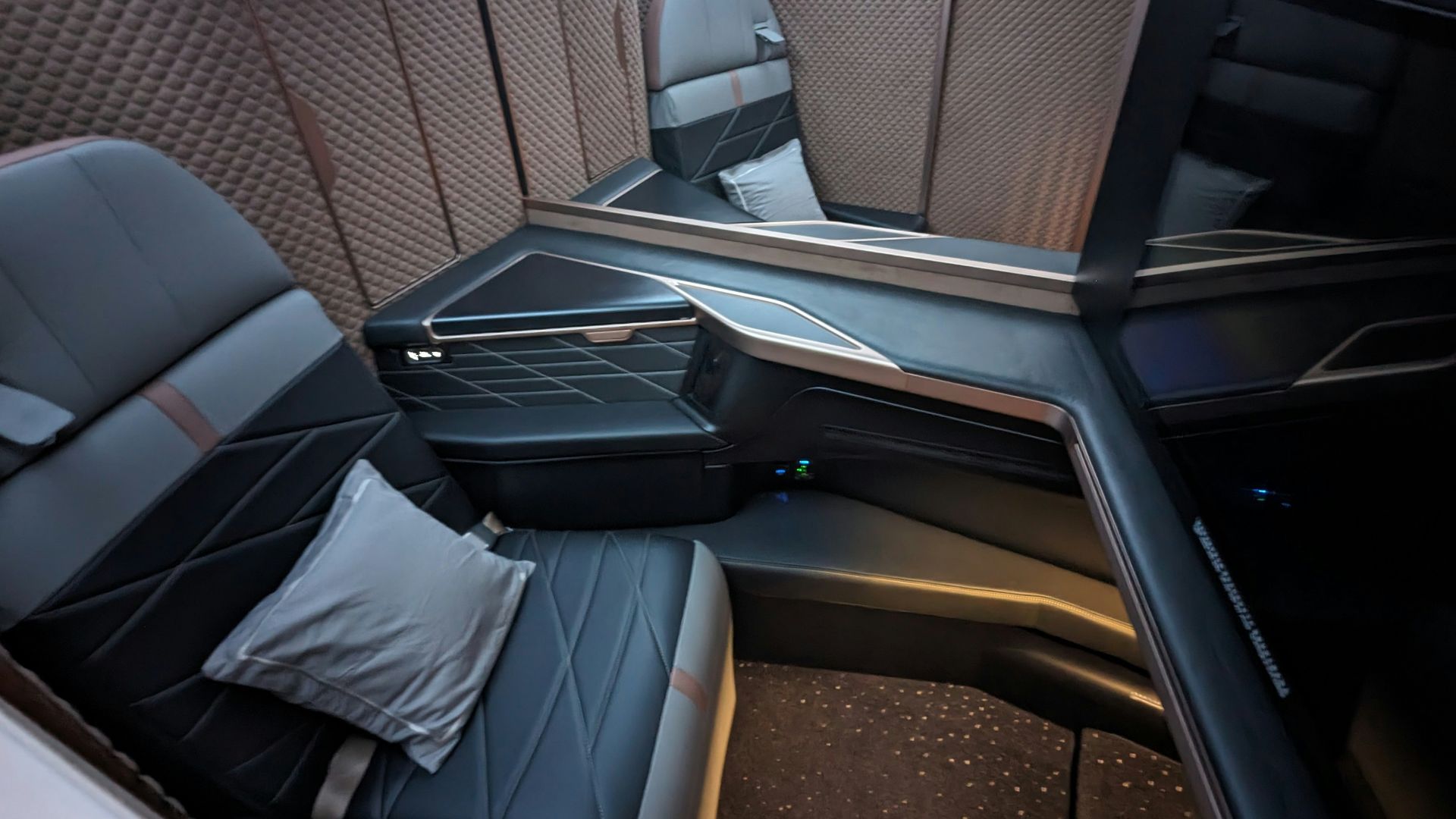 the inside of an airplane with seats and a television