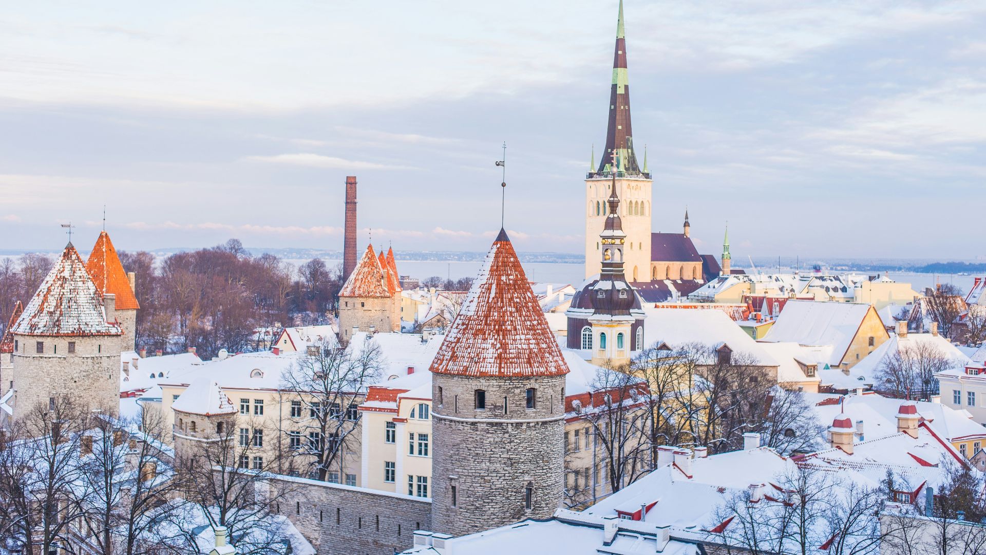 snow covered brown, white, and gray concrete castle under cloudy skies