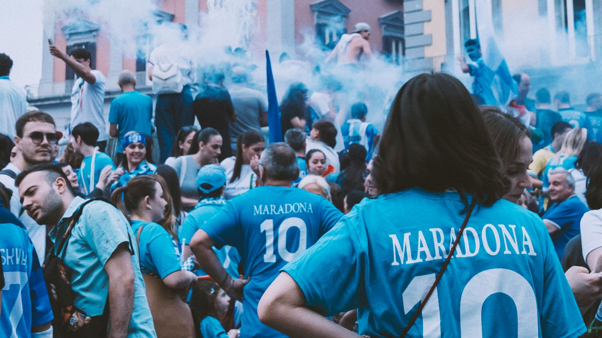 a group of people standing around each other