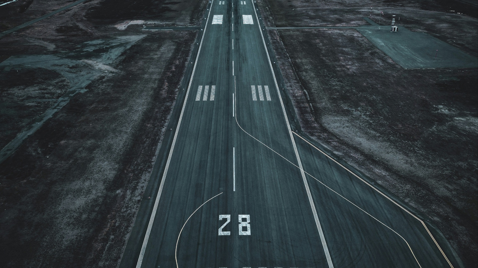 an aerial view of an airport runway at sunset