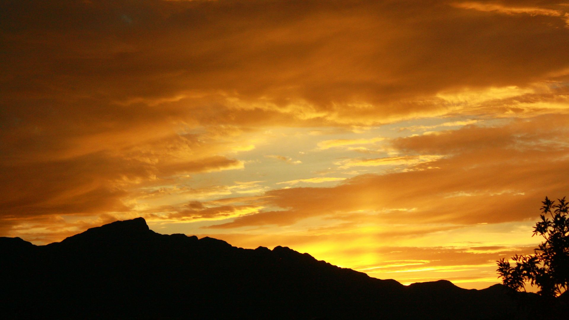 The sun is setting over a mountain range