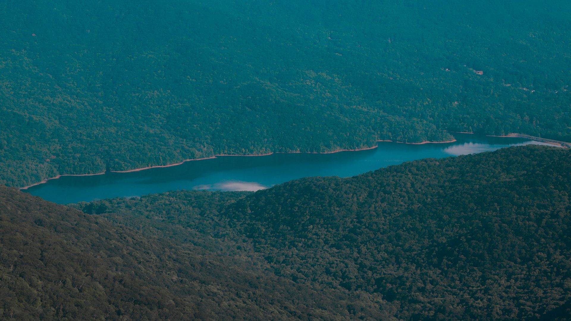 A view of a mountain range with a lake in the middle