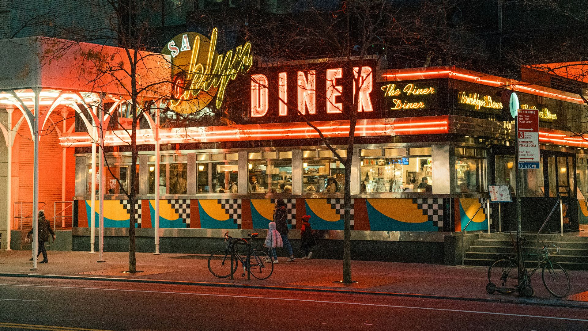 A classic diner illuminated at night on a city street.