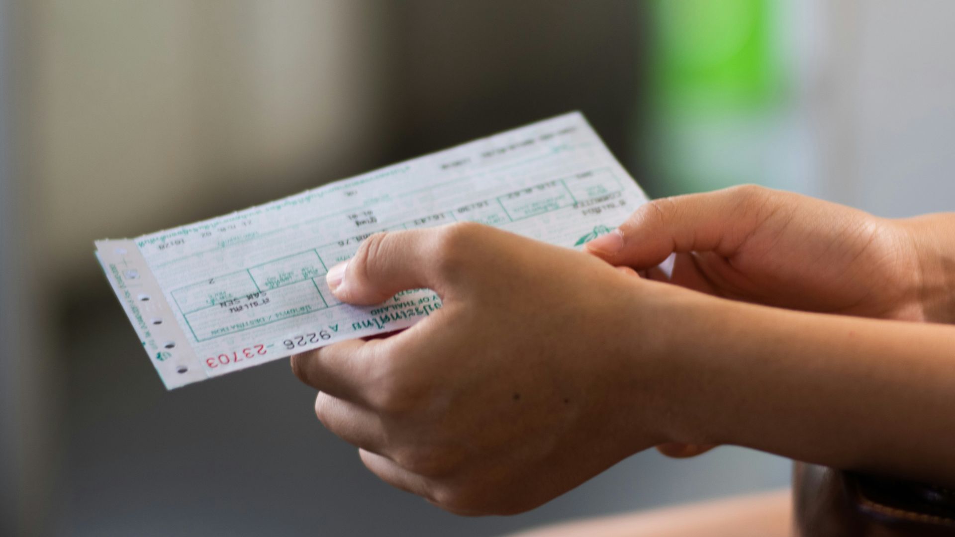 person holding white printer paper