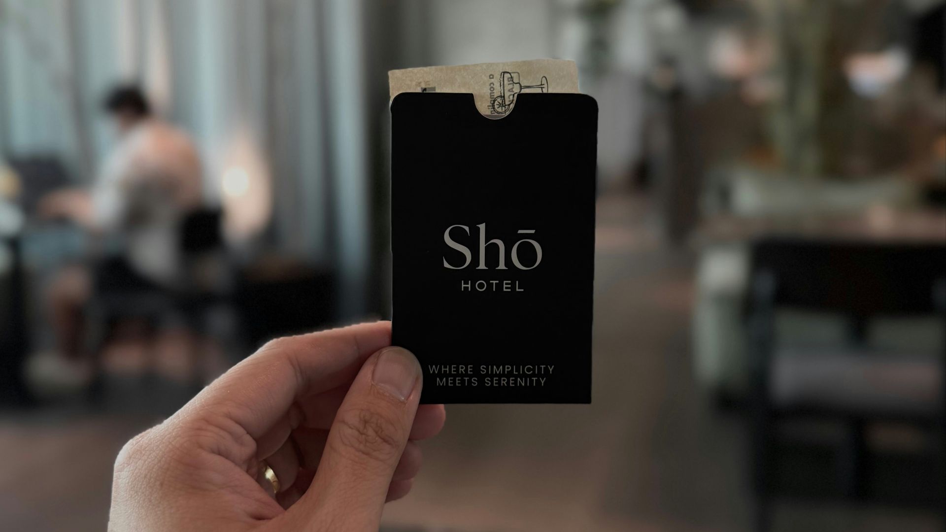 Hand holding a sho hotel key card